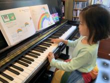 Beginner student Linh wears her rainbow skirt on the day she plays the rainbow piece!